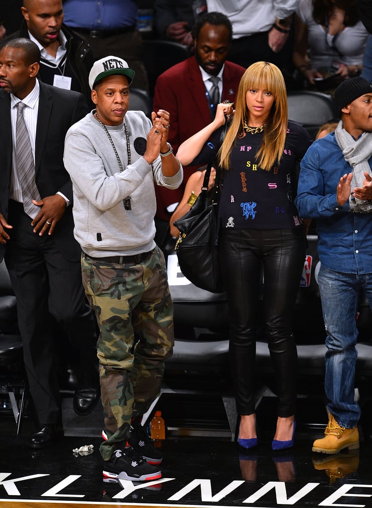 At a New York Knicks game in November 2012, JAY-Z showed off camouflage pants while Beyoncé paired Stella McCartney's alphabet top with leather pants and cobalt pumps.