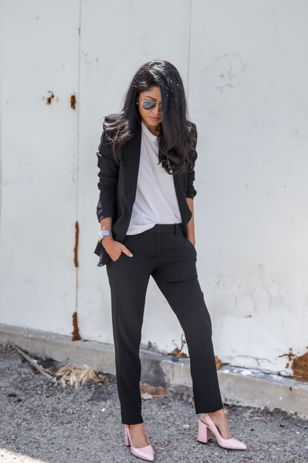 Break up your black-on-black pantsuit with a white tee and neutral pumps.