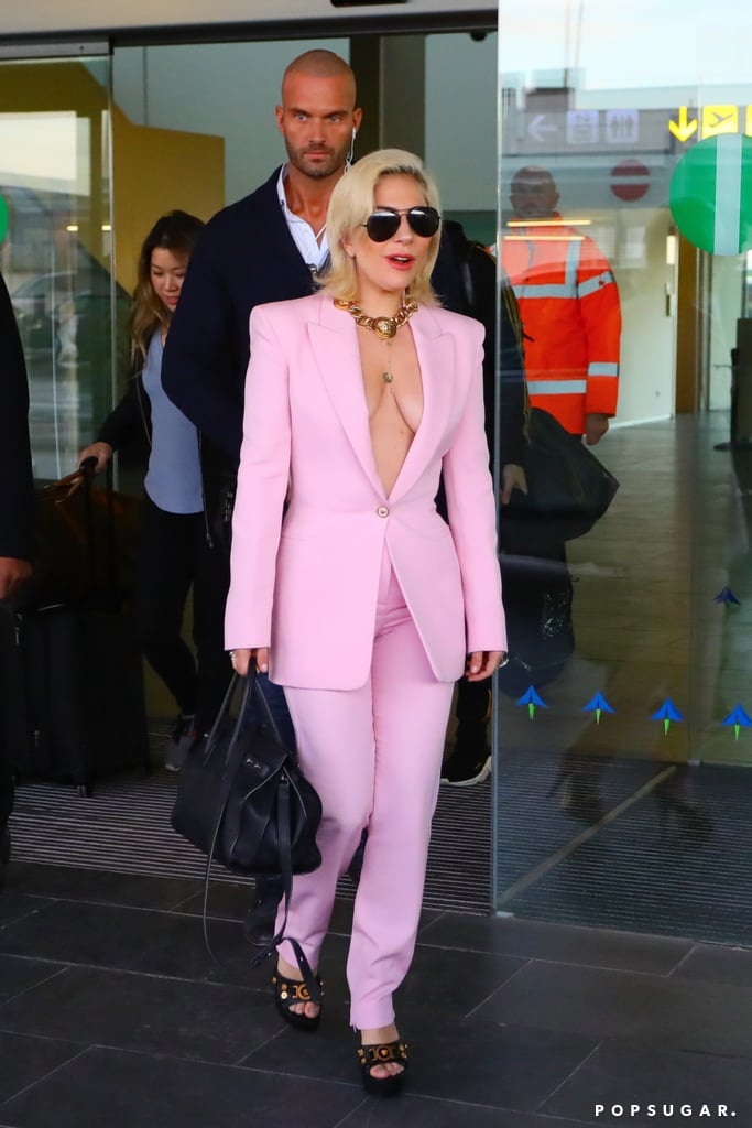 Eleven days into 2018, Lady Gaga was already making a statement in a plunging Versace pantsuit. She touched down in Barcelona, Spain, in the look, which was accessorised with the brand's iconic logo-covered pieces.