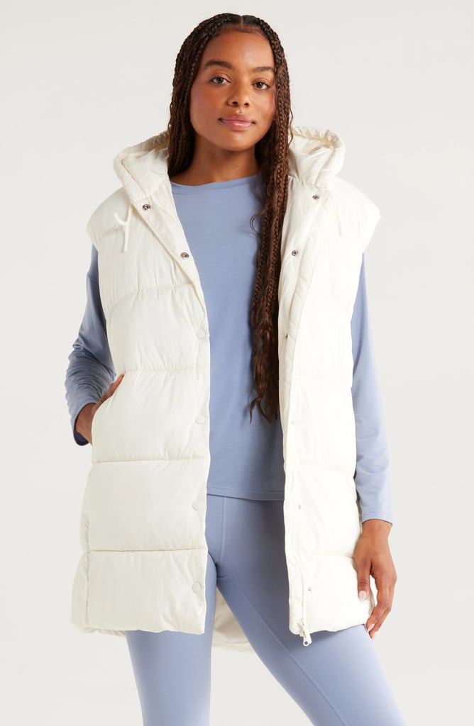 Zella Longline Hooded Puffer Vest ($86, originally $129)
This puffer adds just enough central heat while leaving arms free, making it the perfect outerwear for your gym commute or walk. The hoodie adds extra protection from windy or drizzly days and we love how the length adds butt coverage. Grab it in white, black, or a pretty pale blue.