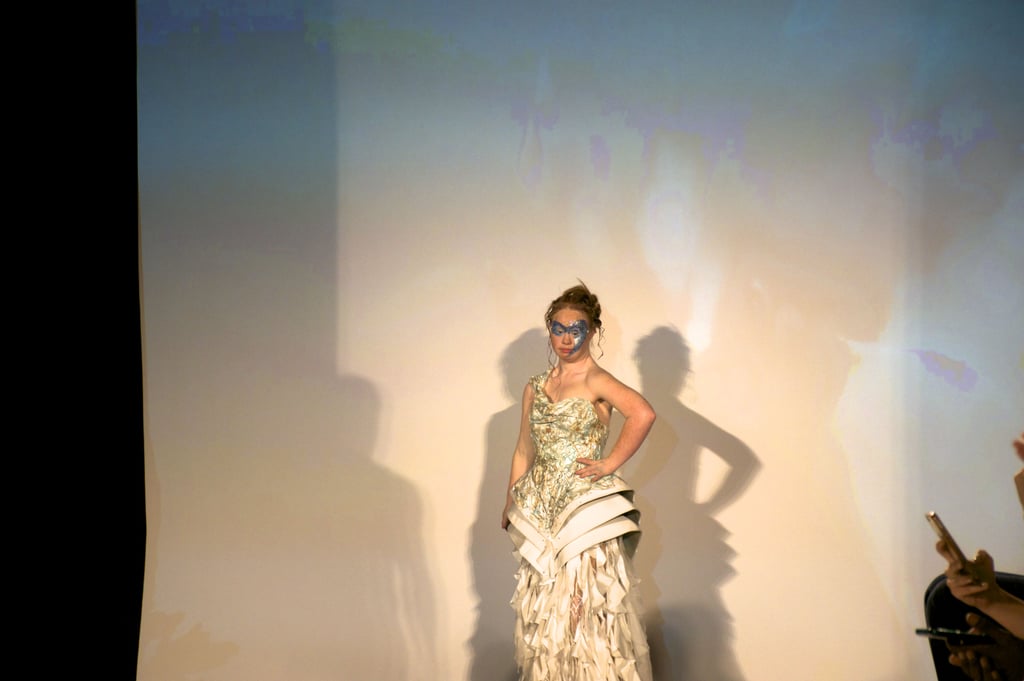 Maddy's first look was a gold textured one-shoulder gown that featured a ruffled train and an ornate bodice. She played up the glow of her dress with shimmering face paint.