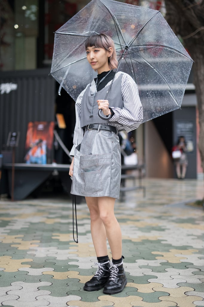 A guest styling a silver minidress with a grey vest during Fashion Week in Tokyo.