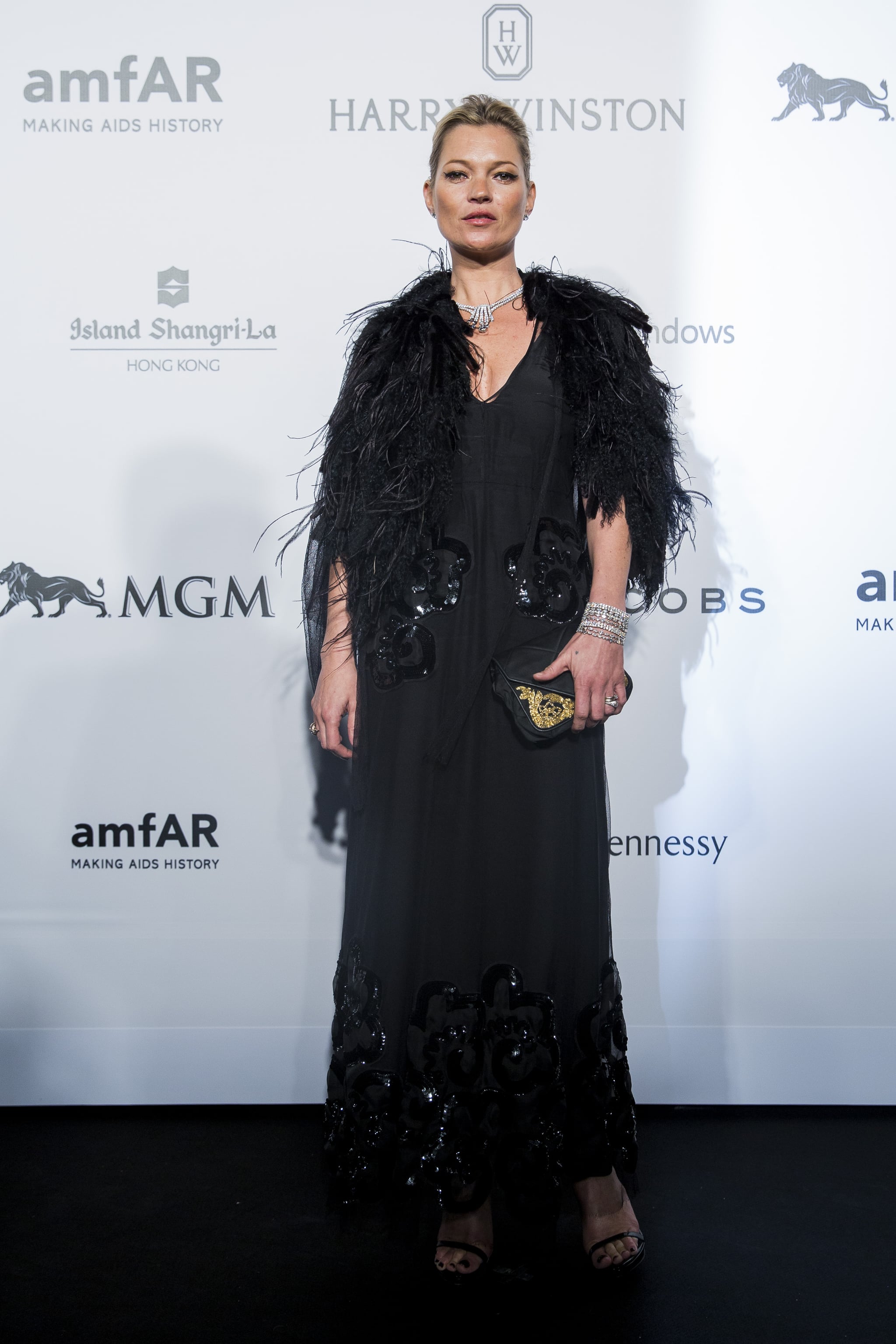 An ostrich-feather cape added a touch of Kate's trademark vintage glam to her long black gown at the 2015 amfAR gala in Hong Kong in March 2015.