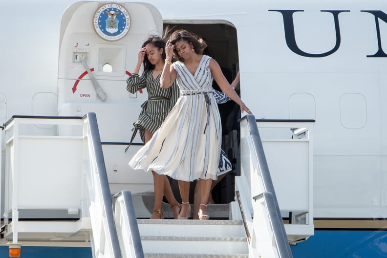 When Michelle and Malia found themselves twinning on a windy day.