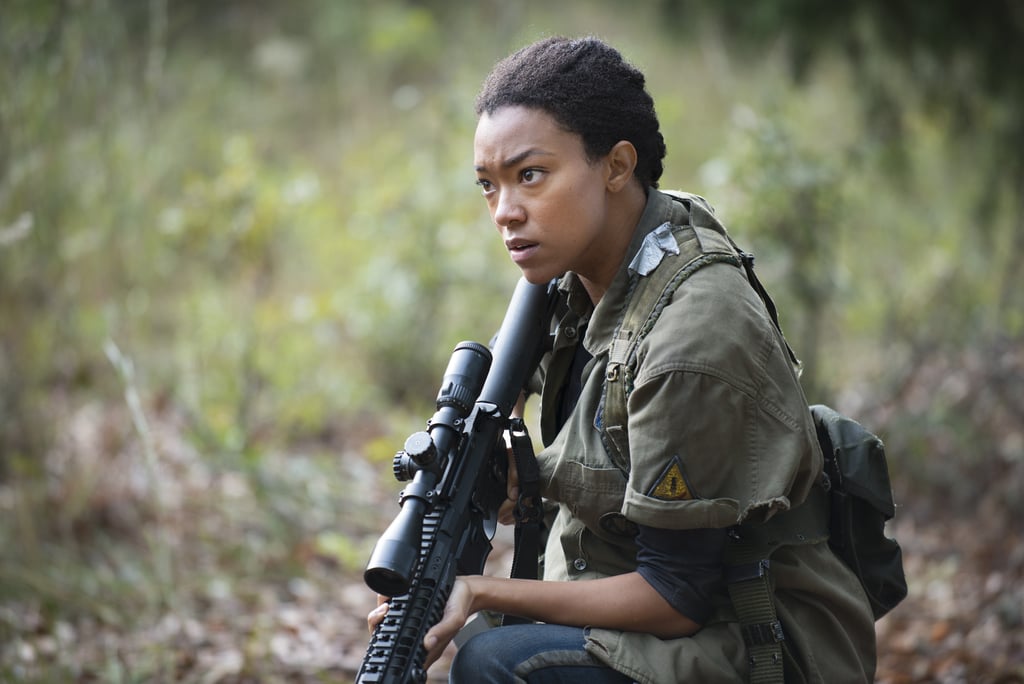 POPSUGAR: The finale ended on a really intense note. Can you talk about where the new season is going to pick up?
Sonequa Martin-Green: Well, we came to a precipice of change, really. You know, you see the Alexandrians really starting to live life the way we know it needs to be lived. It's like the veil has been lifted. And then we see Morgan come in and it's going to be interesting how the dynamic is formed, the new dynamic between Morgan and Rick. I just think it's going to be really compelling, because I attribute the birth of the atmosphere of this story — The Walking Dead's story — to the two of them.
PS: Yeah, that's where it all started!
SMG: They were the major definers of what this world is . . . they had everything to do with that, so I just think it's great that they're coming back together and we're going to see how it all plays out. 
PS: This really is such a full-circle moment. I think the crazy thing is, is that Morgan has been searching for Rick this whole time. He's had in his mind this idea of how Rick would be. How is Morgan going to factor into the new season?
SMG: You've seen Morgan come back. [He and Rick] have both had their breakdowns as men, they've both had tremendous loss, and we've seen them at the brink. The last time we saw Morgan, or the last time they saw each other, he was crazy. He had momentarily lost his mind. . . . We're definitely going to see that we're going to get into a bit of his journey and see how he got there how he got out how he got to where he is.
PS: Going back to Sasha. In season five alone she experienced so much loss. Are we still going to see her struggle, or does she finally have a chance to mend?
SMG: What I've been saying a lot is that you certainly hope that there's mending. You certainly hope that there's light at the end of the tunnel, that you find a reason to move on. To keep going forward. We saw her get as low as you can. . . . As Sasha, I'm facing the decision of death or life. Everything's been stripped away from me where I'm down to that basic question.
PS: And in this world, SO many people are facing that question: "Do I keep going or do I give up?"
SMG: Right. Exactly. It's a theme. It's an undercurrent of the show, and it always has been. We live in a world of death, and it has a lot of different meanings. So, I'm facing that question like never before, because now I have the memories of these great men and I have a choice to make. And I hope it's the right one.