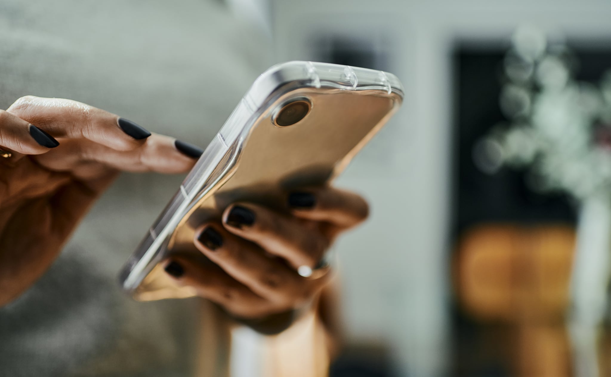 Close-Up of Woman Texting on Mobile Phone with Copy Space