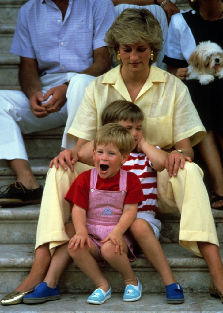 Princess Diana sat with Prince Harry and Prince William while on vacation in Majorca, Spain, in August 1987. Princess Diana sat with Prince Harry and Prince William while on vacation in Majorca, Spain, in August 1987.