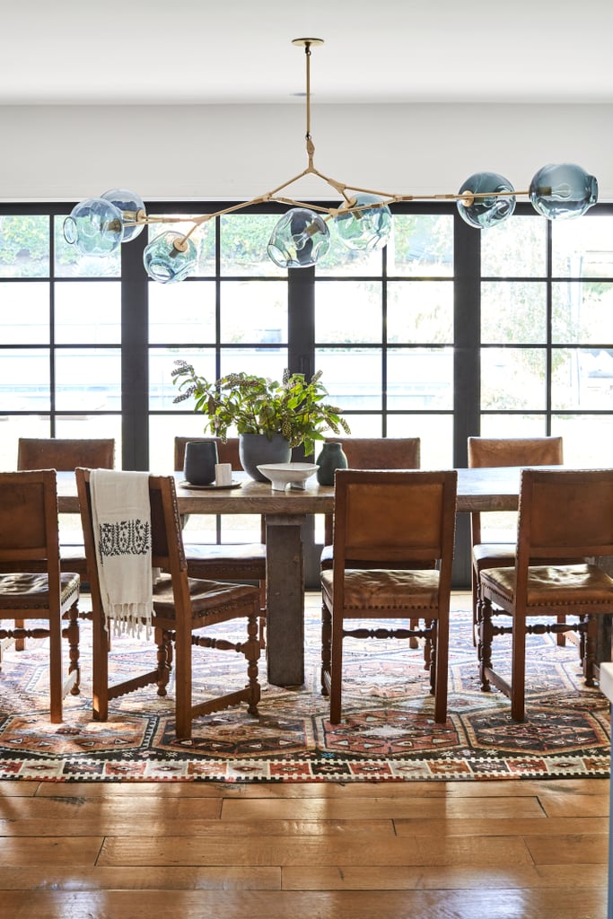The actress is a master at combining new and old styles, and no space illustrates that more clearly than her spacious dining room. Check out how her rustic table and rug balance out a modern light fixture. It's seriously perfect.