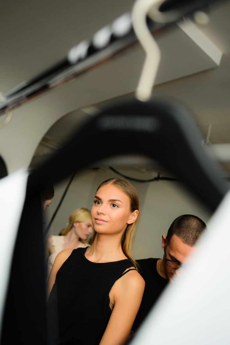 A Model Backstage at the Jonathan Simkhai Presentation