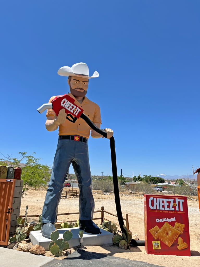 Local Joshua Tree celeb Big Josh is posted up outside next to a giant Cheez-It box with his own giant pump in hand.