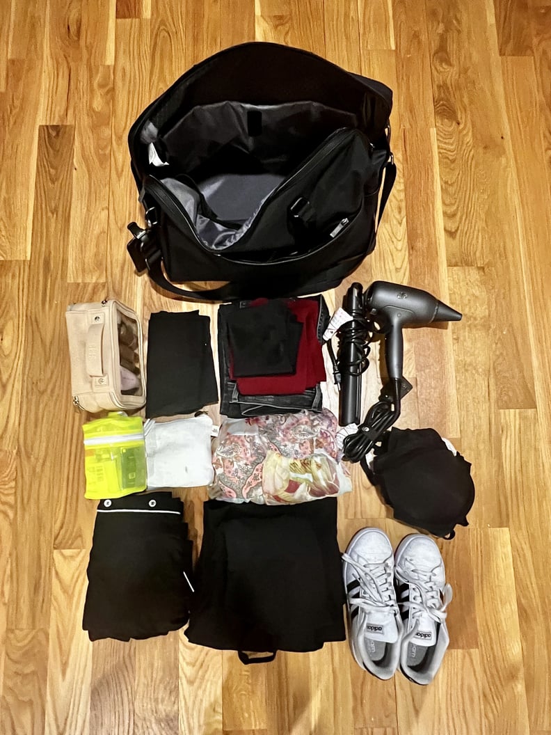 The Open Story Weekender Bag packed with travel essentials including sneakers, makeup bag, skin-care kit, and toiletries pouch, a pair of jeans, a sweater, my undergarments, a travel hair dryer, and a straightener, a dress, a jumpsuit, a pair of pajamas, 