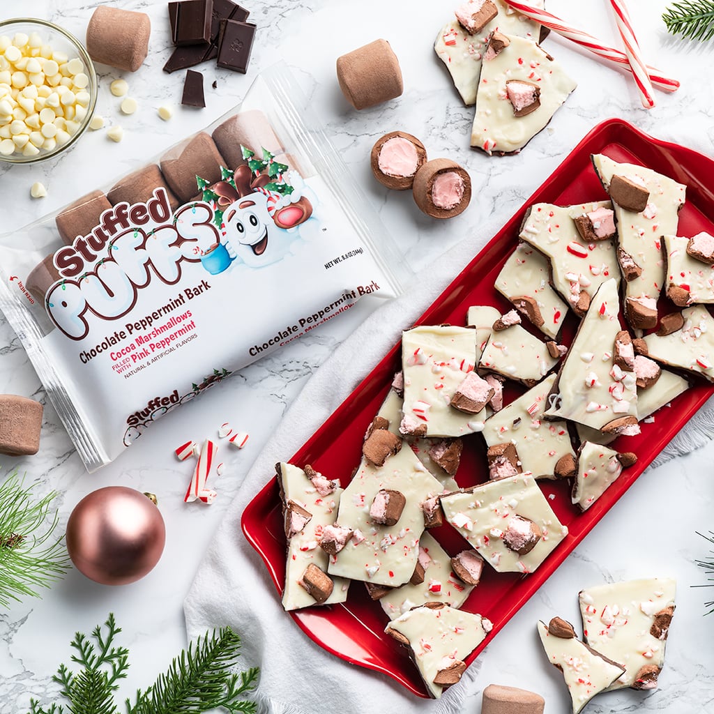 Break out the mugs and the cocoa mix, because there's a new minty treat in town that's begging to be added to your next hot drink. Stuffed Puffs — the brand known for its chocolate-stuffed, s'mores-ready marshmallows — is rolling out a peppermint bark-inspired product especially for the holidays. 
The Chocolate Peppermint Bark Marshmallows feature a cocoa exterior, and are filled with a pink peppermint and white chocolate center for a decadent dessert experience. Yum! If you're a baking fanatic like me, consider adding the 'mallows to your next kitchen experiment — like Rice Krispies Treats with a seasonal twist. There are plenty of uses for these tiny treats, so mark your calendars for their in-store release at places like Walmart, CVS, and Kroger starting in early November. If you can't wait that long, don't worry, you can snag a bag online today at Stuffed Puffs' digital shop. 

    Related:

            
            
                                    
                            

            Son of a Nutcracker! Oreo&apos;s Gingerbread Cookies Are Packed With Crunchy Sugar Crystals