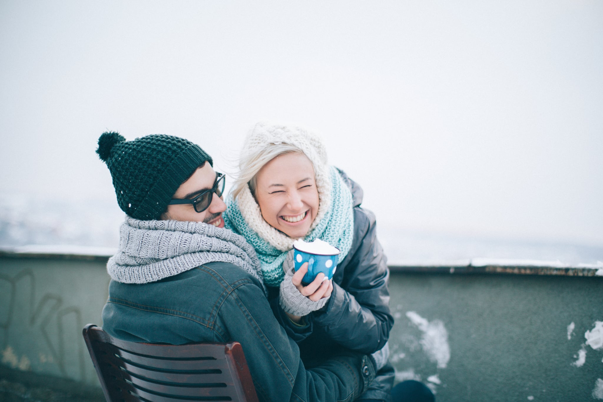 Loving couple enjoying the winter on Valentine's day on the rooftop of a building