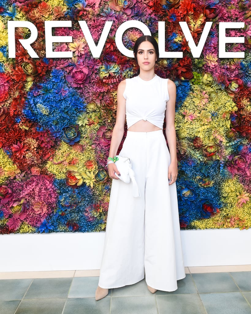 Amelia Gray Hamlin wearing wide-leg trousers and a knotted tee at the Revolve Festival party. 