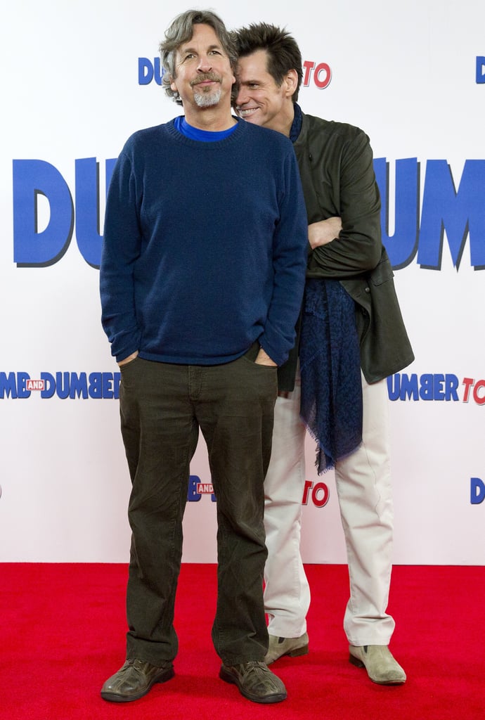 Jim Carrey got silly with director Peter Farrelly at a photocall for their movie Dumb and Dumber To in London on Thursday.