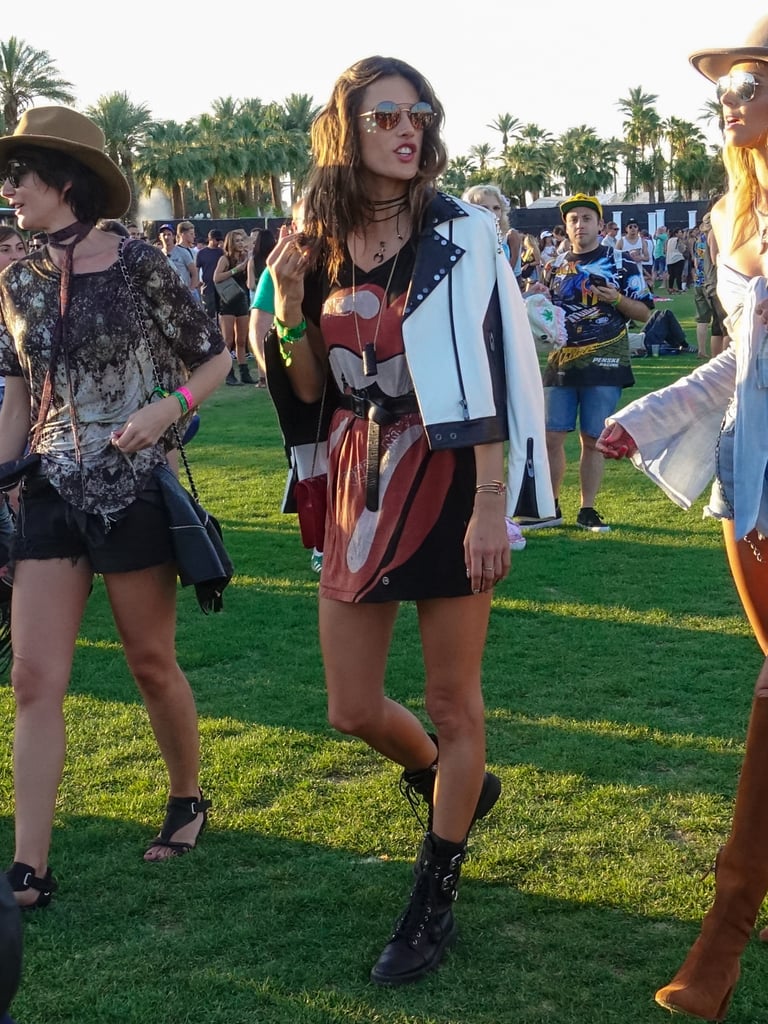 Alessandra Ambrosio wearing a graphic tunic, leather jacket by The Mighty Company, and boots at the festival. 
