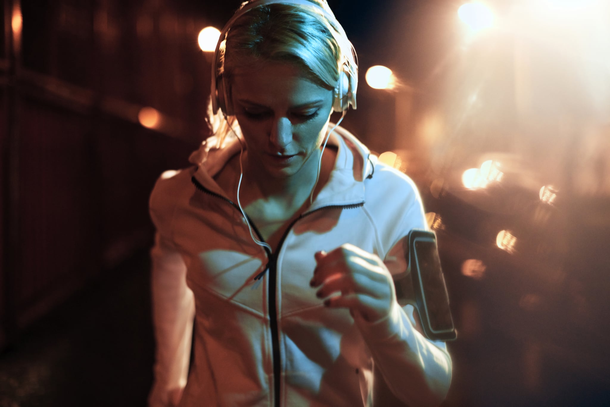 Close up of a young woman having a night jog