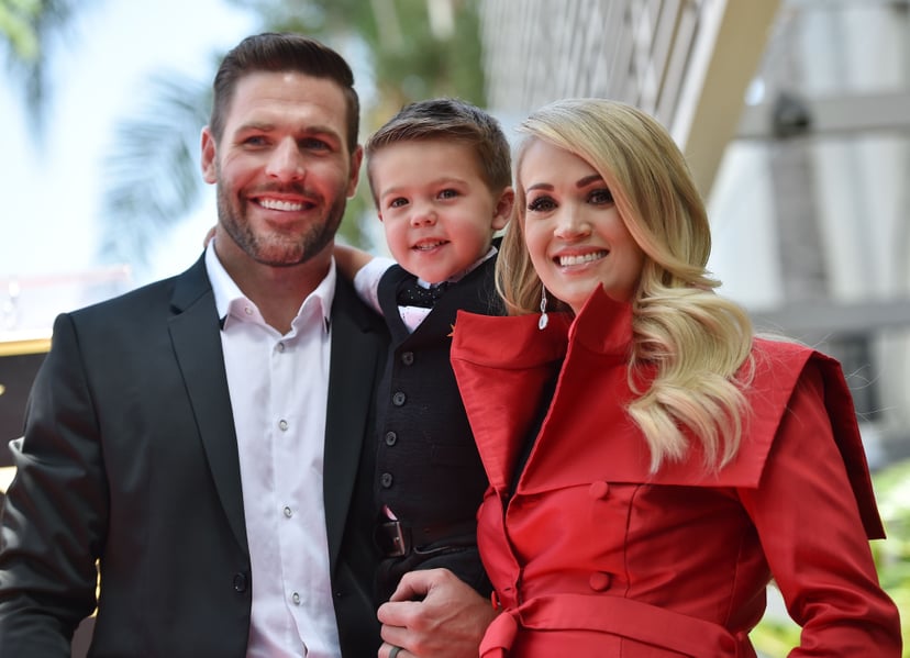 Singer Carrie Underwood poses with her husband Mike Fisher and their 3-year-old son Isaiah Michael at her star unveiling ceremony on the Hollywood Walk of Fame, September 20, 2018 in Hollywood, California. (Photo by Robyn BECK / AFP)        (Photo credit 
