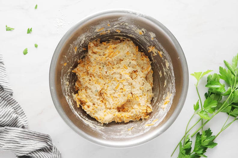 Mixing cheese into biscuit batter