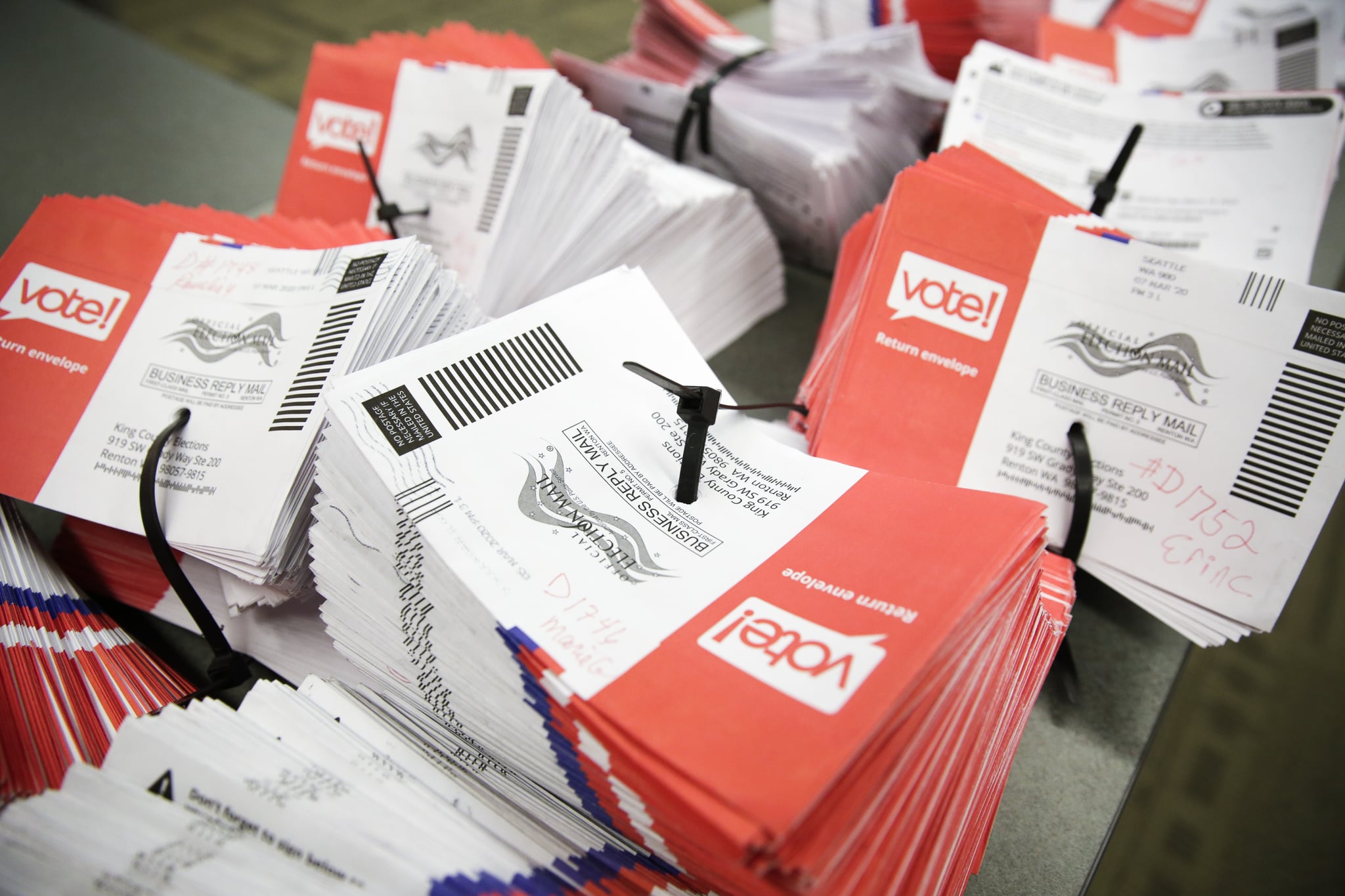 Empty envelopes of opened vote-by-mail ballots for the presidential primary are stacked on a table at King County Elections in Renton, Washington on March 10, 2020. (Photo by Jason Redmond / AFP) (Photo by JASON REDMOND/AFP via Getty Images)