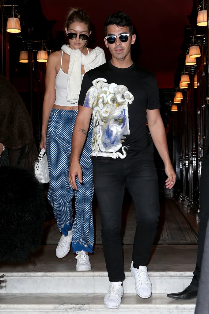 Gigi and Joe Jonas headed to lunch in Paris, coordinating their blue and white outfits. We love how Gigi tied her sweater loosely around her shoulders, adding a preppy hint to her white cropped tank and printed palazzo pants.