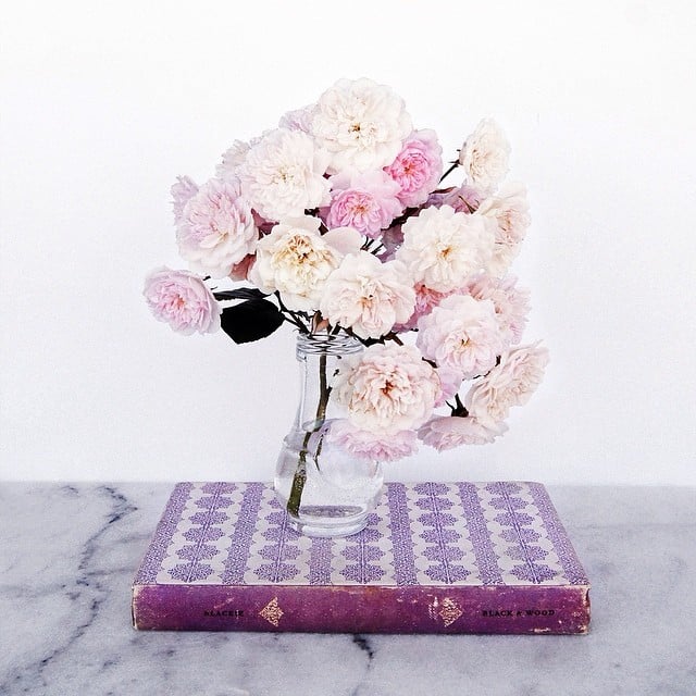 Stuff a vase with garden roses, and then place it on top of a book of the same color. 
Source: Instagram user corinanika