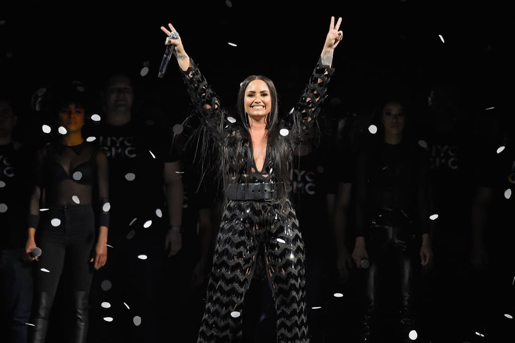 Spreading love! Lovato threw up deuces to her fans in a black sequinned bodysuit at the Barclays Centre in New York City in 2018.