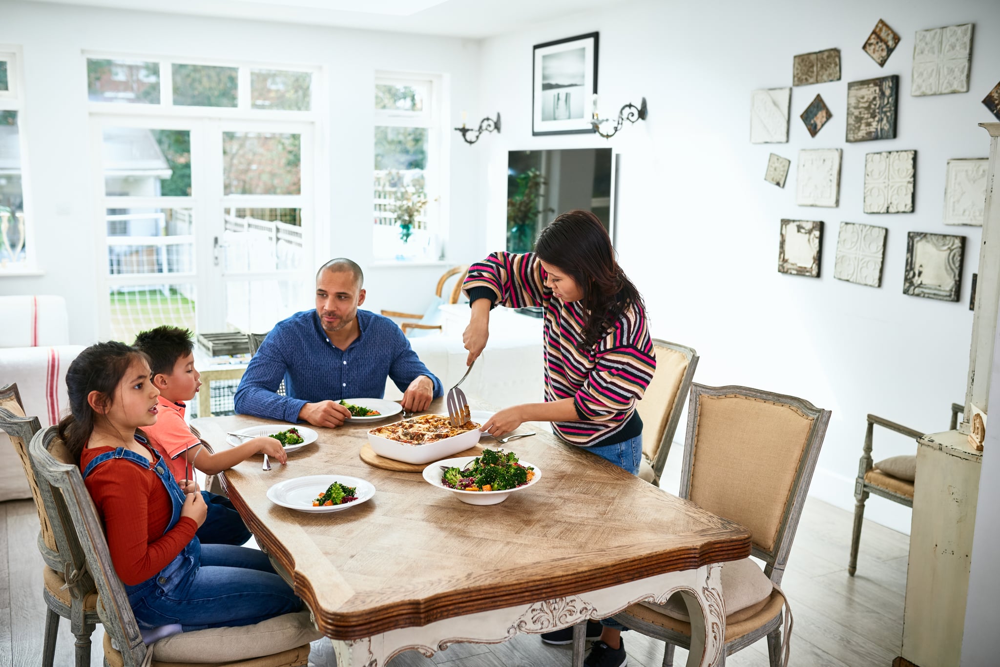 Family meal time in dining room with freshly cooked home made dinner, domestic life, family, food and drink