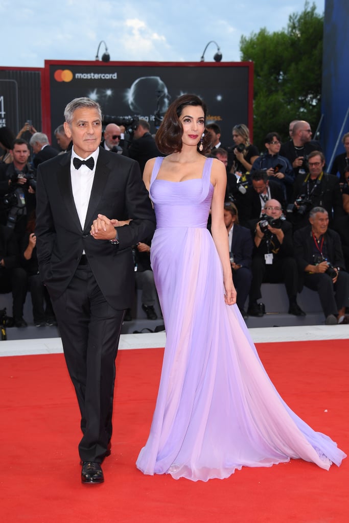 For the 2017 Venice Film Festival, Amal showed up to the red carpet in a stunning lavender Atelier Versace gown. She wore Aquazzura sandals and Lorraine Schwartz drop gemstone earrings.