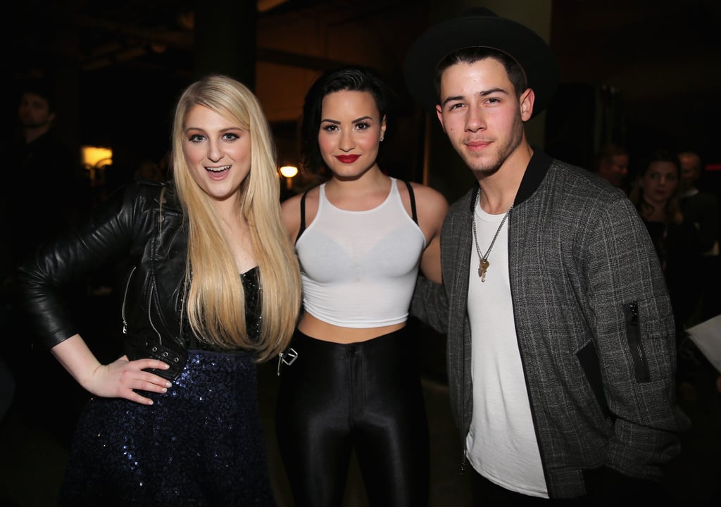 Meghan Trainor, Demi Lovato, and Nick Jonas posed together on Monday at the Jingle Ball in St. Paul, ME.