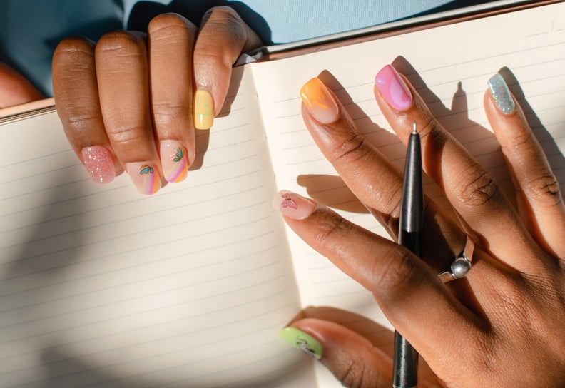 hands holding a pen over an empty notebook