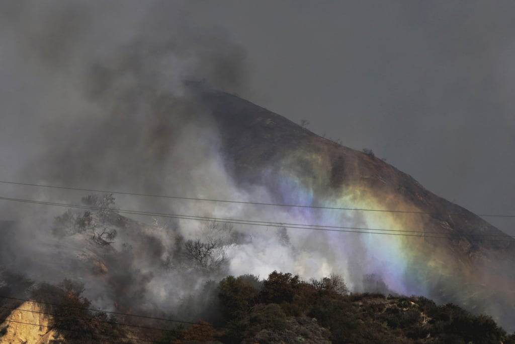 Planes flew over the wildfire as it burned the hillside.