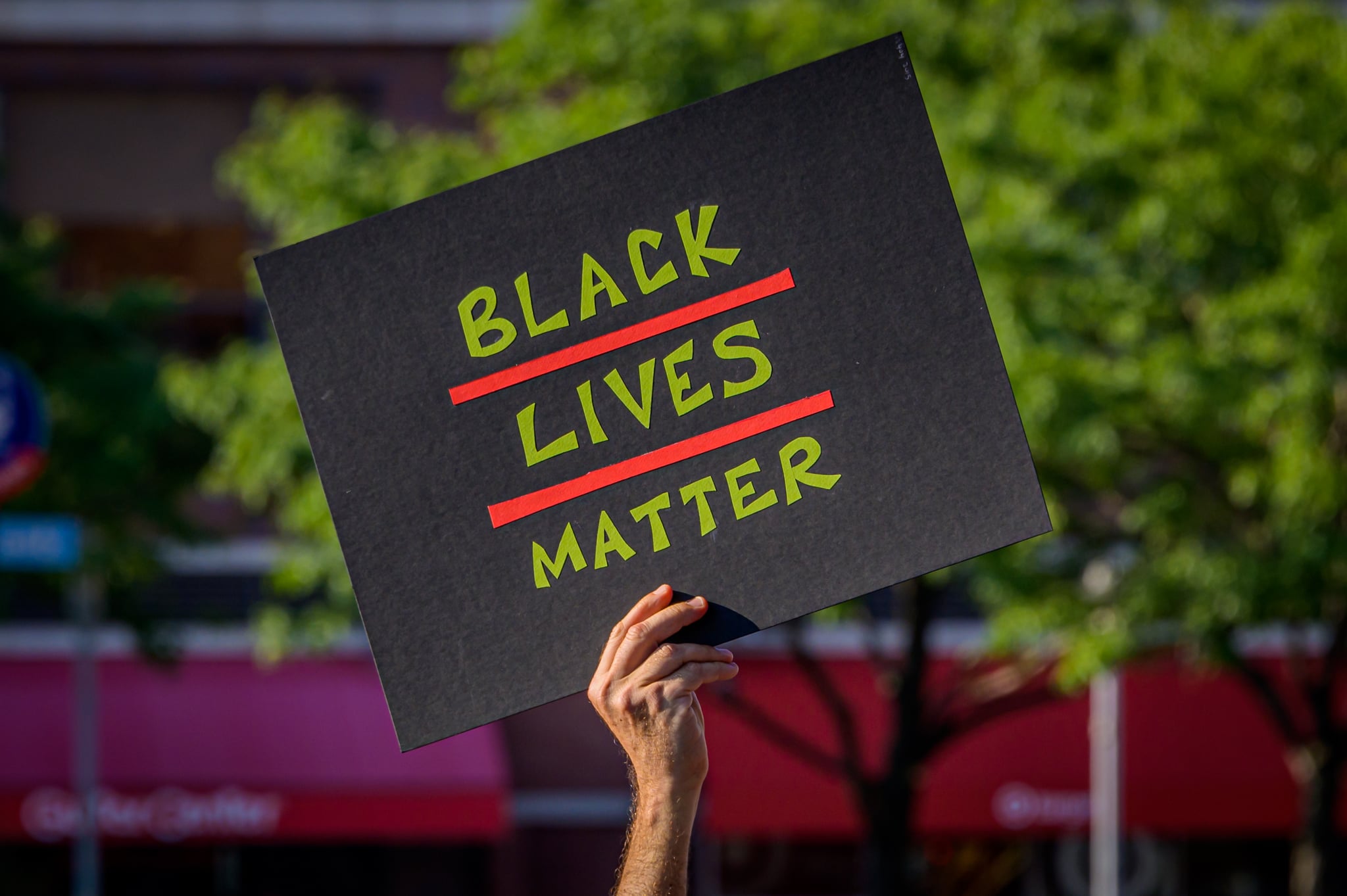 BROOKLYN, NEW YORK, UNITED STATES - 2020/07/31: A participant holding a Black Lives Matter sign at the protest. Brooklynites gathered at Barclays Center for a march in the streets of Brooklyn, demanding justice for all victims of police brutality, bringing light to the NYPD actions, snatching protesters and taking them away in unmarked vans, also to make a loud call to defund the NYPD and invest in communities. Street Riders NYC participated by sending bikes to act as a buffer and shield protesters from cars and police. (Photo by Erik McGregor/LightRocket via Getty Images)