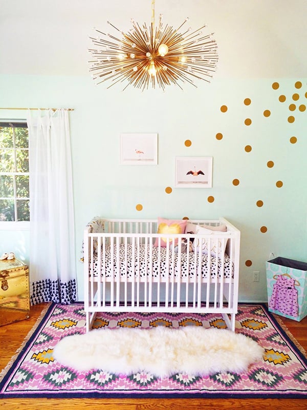 We're charmed by this delicious, unexpected palette of green, gold, and pink. The midcentury-modern-style chandelier and metallic dots, both from Etsy, are imaginative twists on vintage style — and great nursery ideas for a retro-minded rehabber like Nicole.