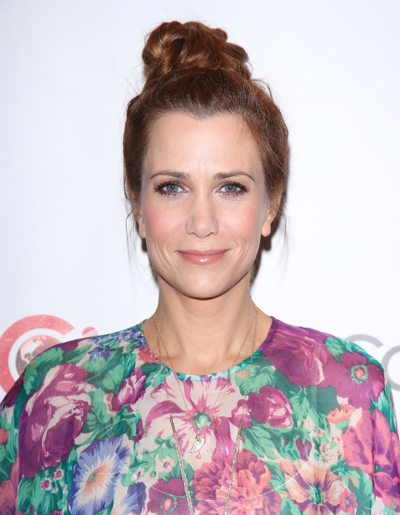 Kristen Wiig swept her hair up into a precarious topknot that will keep your hair color safe from chlorine when you take a dip this Summer.