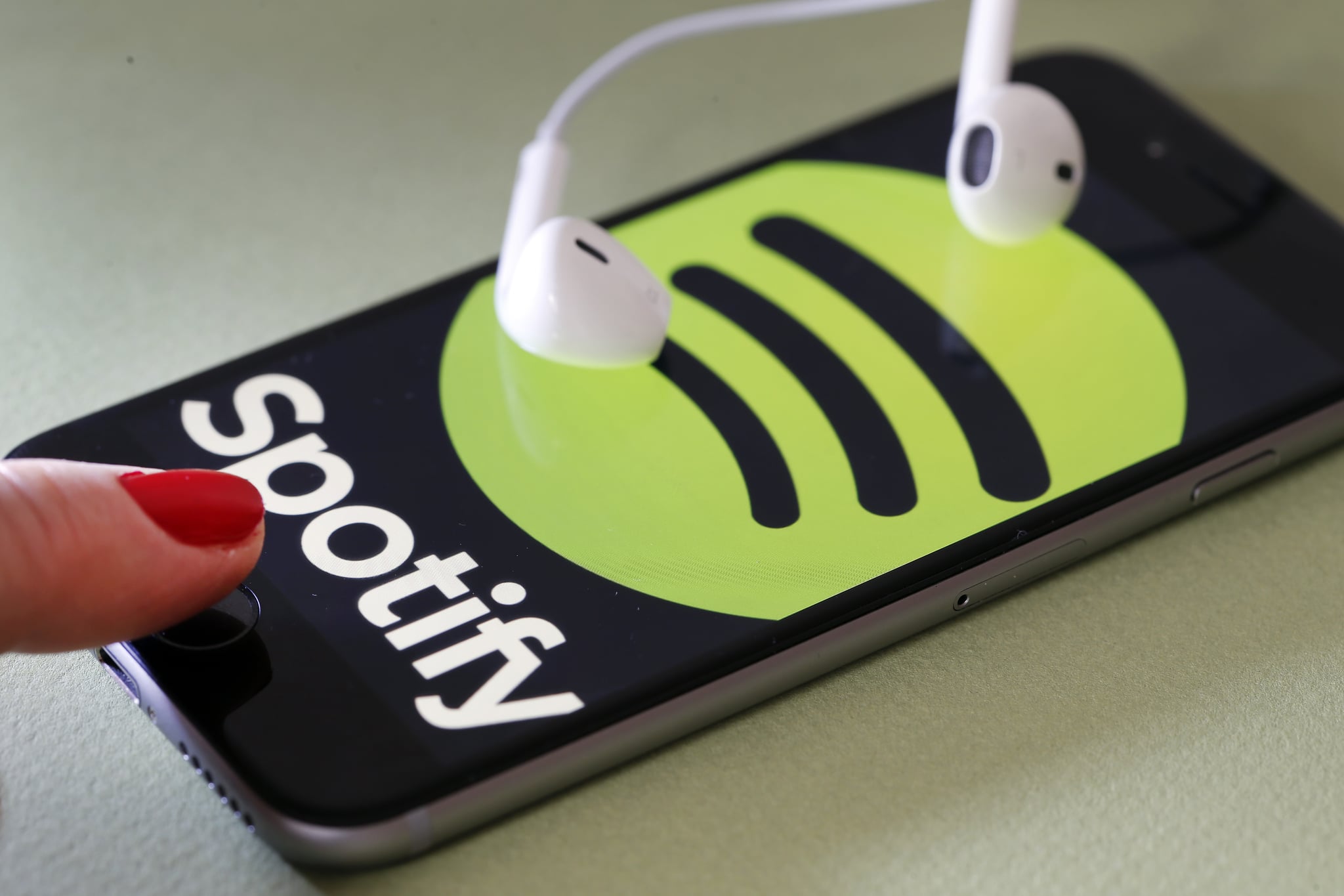 PARIS, FRANCE - JANUARY 06:  In this photo illustration, the logo of the Swedish music streaming service Spotify is displayed on the screen of an iPhone on January 06, 2017 in Paris, France. Spotify announced, via a tweet published Thursday, that it now has 70 million paid subscribers. As a comparison, in September, Apple Music claimed 30 million subscribers and Deezer had fewer than 10 million subscribers. Spotify, the world's largest streaming music company, is expected to be listed on the Wall Street stock market in the first quarter of 2018.  (Photo by Chesnot/Getty Images)