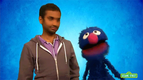Aziz Ansari hanging out with Grover from Sesame Street.
