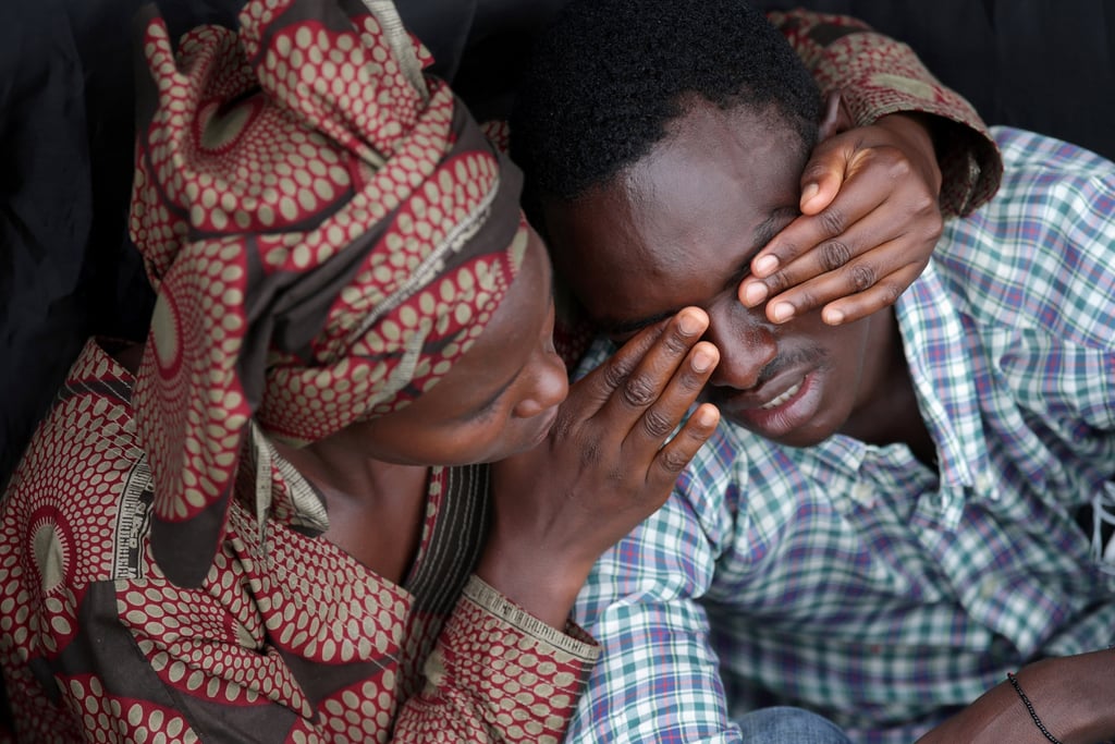 Twenty-two-year-old Bizimana Emmanuel was consoled by a female friend as they commemorated the lives lost at today's ceremony in Kigali.