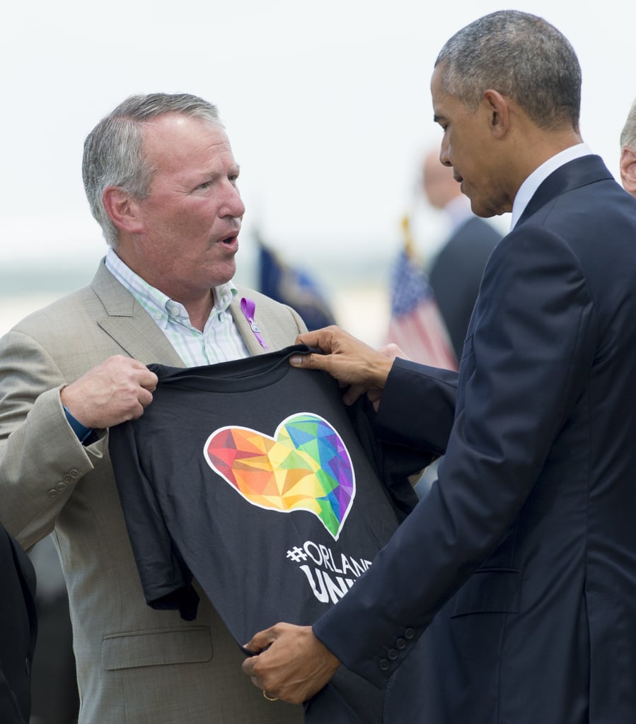Orlando Mayor Buddy Dyer gives President Obama an "Orlando United" t-shirt at the Orlando International Airport.