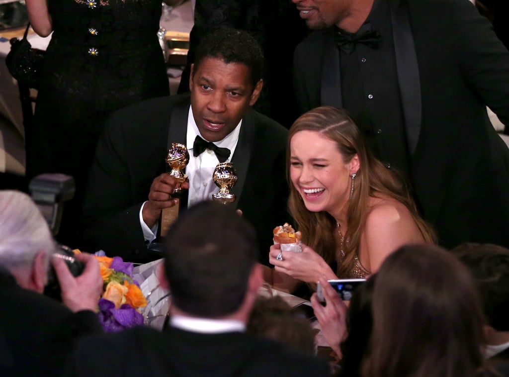Denzel Washington cracked up with Brie Larson, who was eating a burger.