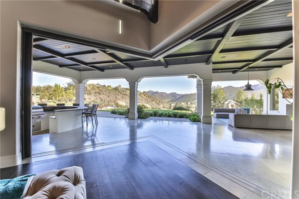 The home opens to a large outdoor entertainment area.