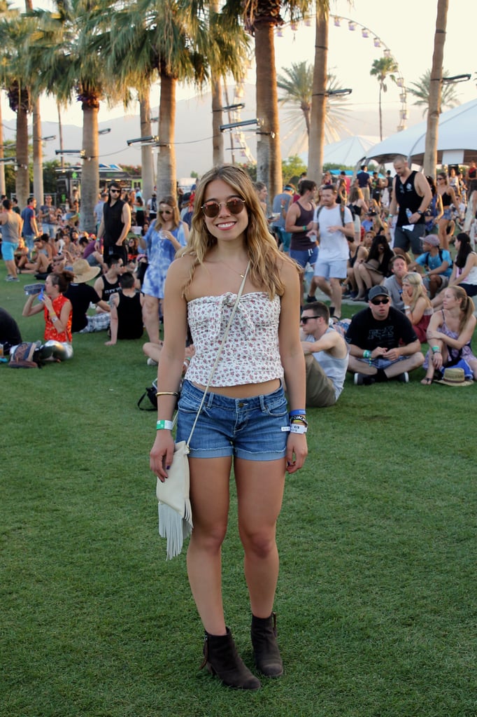 Popsugar Fashion Editorial Assistant Sarah Wasilak paired her floral strapless top from Urban Outfitters with denim shorts, brown Dolce Vita booties, Ray-Ban sunglasses, and a fringe Hobo bag.