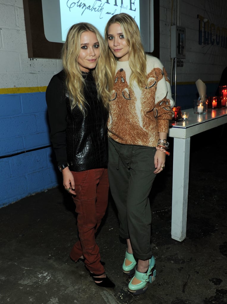 Twinning combo: The twins put their cool-girl spin on cargo pants at a Textile Elizabeth and James celebration in 2011.

Mary-Kate opted for a Fall-friendly palette wearing a black crocodile sweater with rust-hued pants and pointed pumps.
Ashley went cheeky in a fox-print sweater, cuffed army-green pants, and futuristic mint Mary Janes.