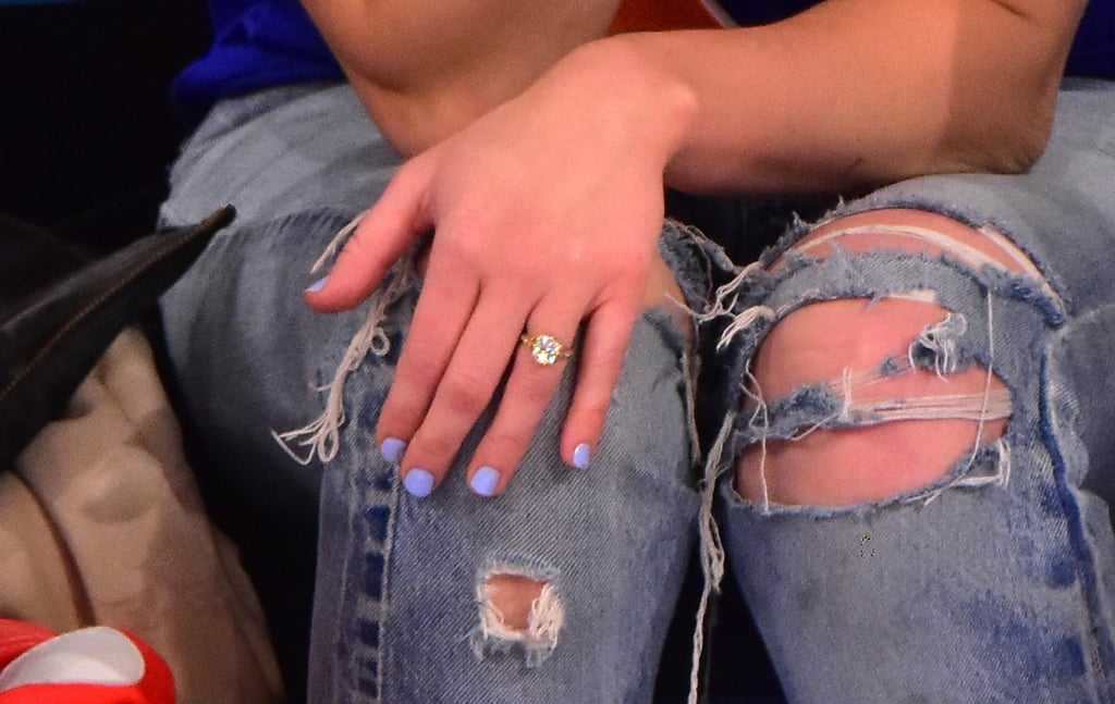 Up close, the diamond sparkled against her casual outfit and was highlighted by her purple mani.