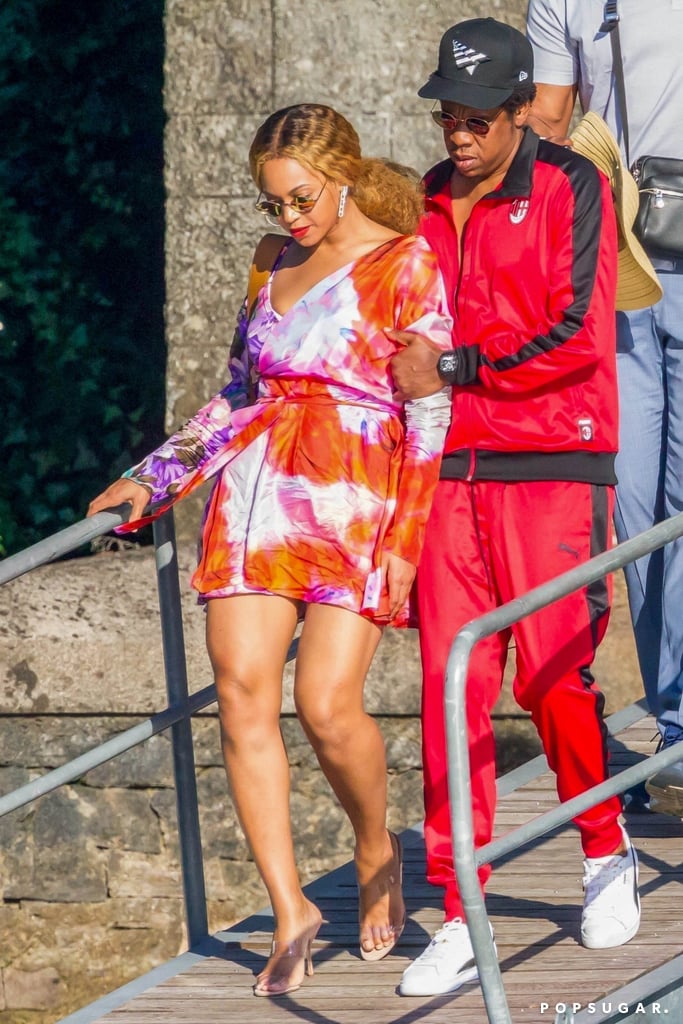Beyoncé is enjoying some alone time with hubby JAY-Z. The singer, who's currently on the On the Run II tour, was spotted boarding a yacht in Lake Como, Italy. For their romantic boat trip, Beyoncé wore a wrap minidress by MSGM that featured a fun floral tie-dye print. 
The "Crazy in Love" singer's Summer-approved outfit put her toned legs on full display. Bey finished off her look with a pair of PVC Ritch Erani Clara Sandals ($525), statement earrings, and geometrical sunglasses. Read on to get a closer look at Beyoncé's outfit, and buy her exact dress, as well as more affordable versions, ahead.

    Related:

            
            
                                    
                            

            Beyoncé&apos;s Black Feather Heels Are SO Wild, of Course Only She Could Pull Them Off