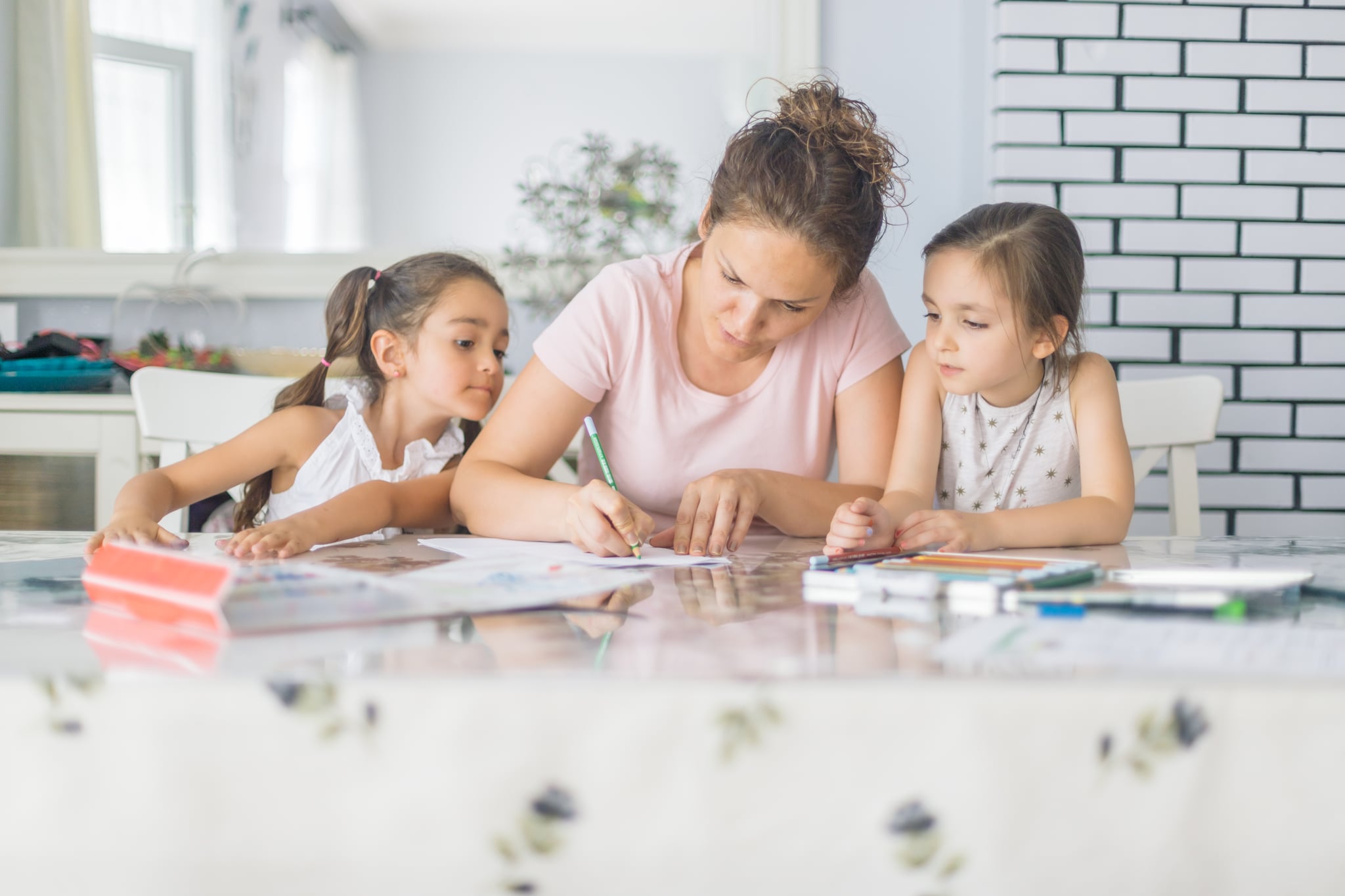 Mother helping daughters with homework