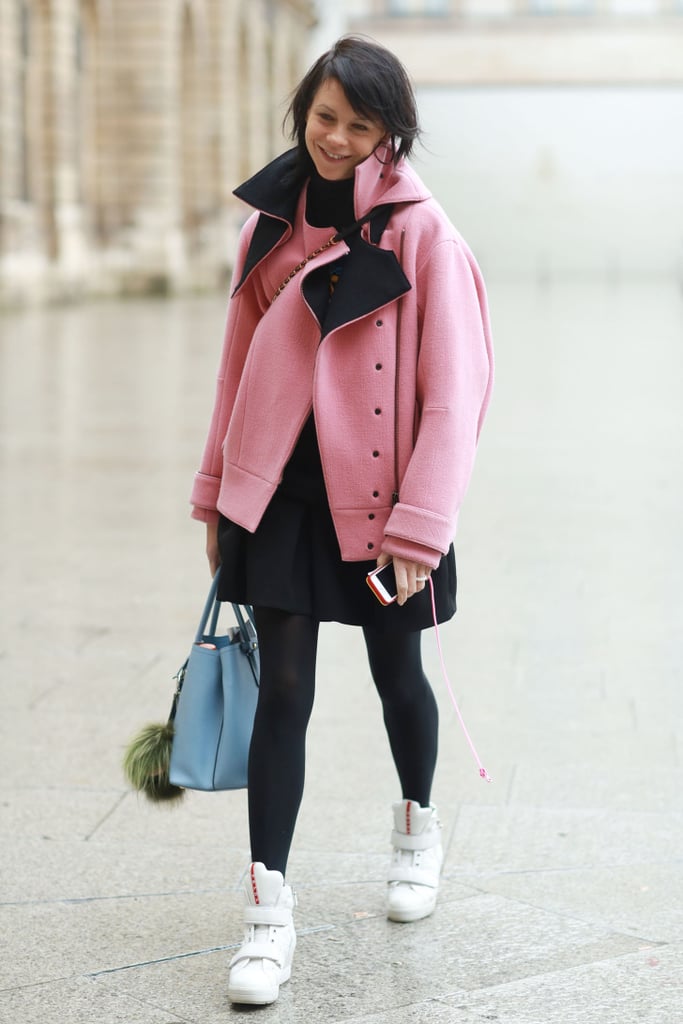 Yes, sneakers even work with tights. The proof is this ultrachic take with a Spring topper and Prada high-tops on bottom. 
Source: Tim Regas