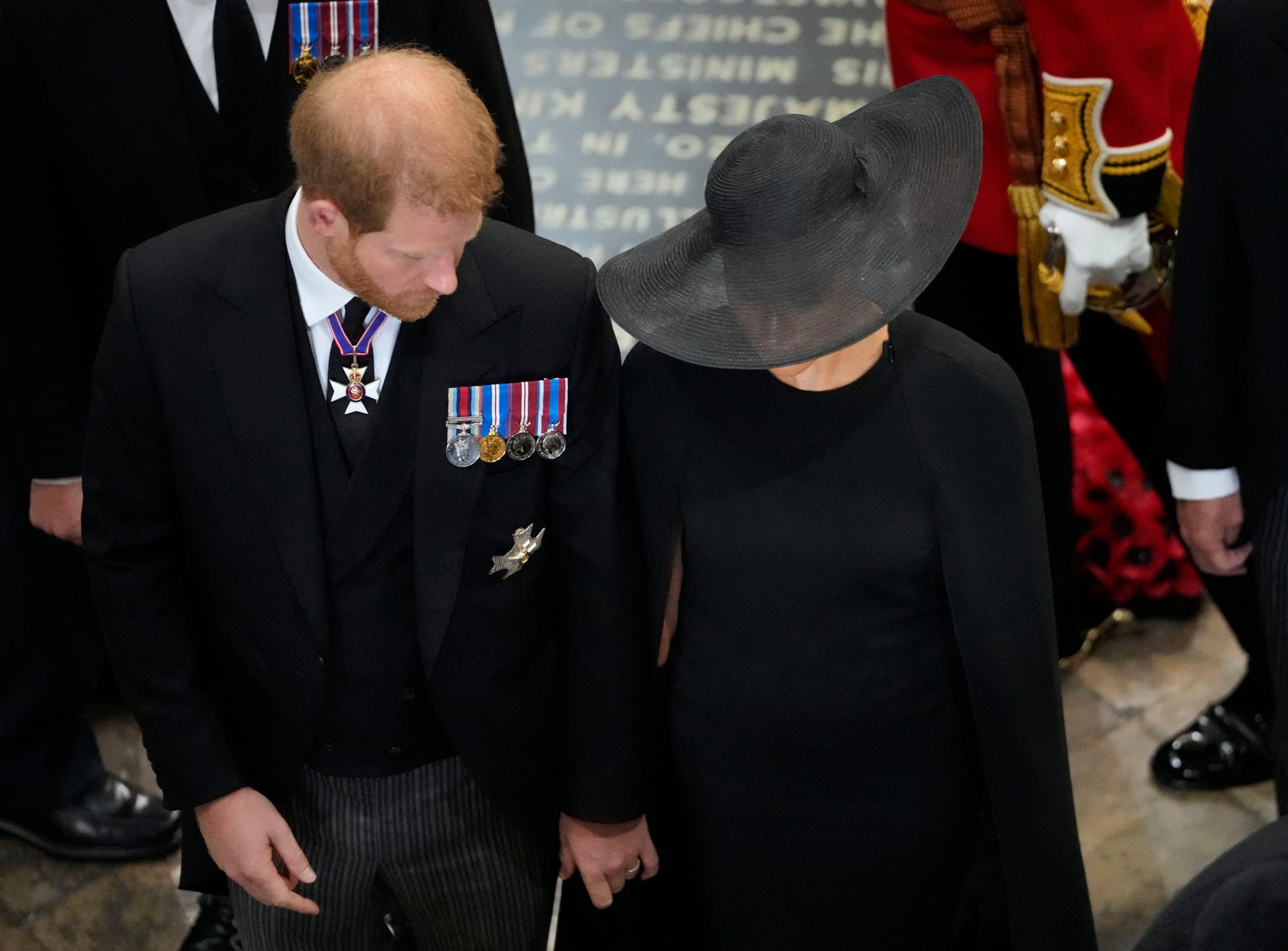 Britain's Prince Harry, Duke of Sussex and Meghan, Duchess of Sussex follow the coffin of Queen Elizabeth II as it is carried out of Westminster Abbey during her funeral in central London on September 19, 2022. (Photo by Frank Augstein / POOL / AFP) (Photo by FRANK AUGSTEIN/POOL/AFP via Getty Images)