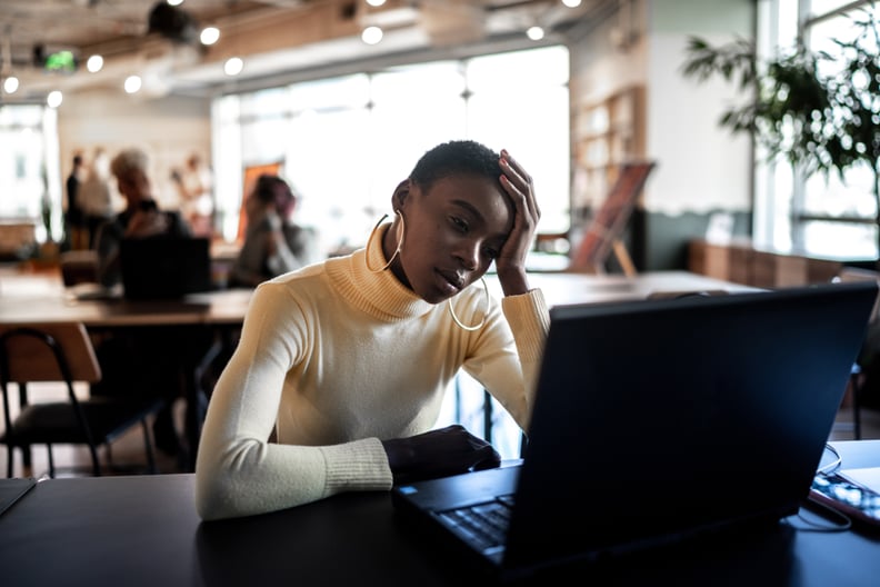 Worried businesswoman looking at laptop