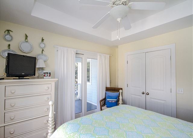 The bright bedroom will have you feeling like you're right next to the beach.